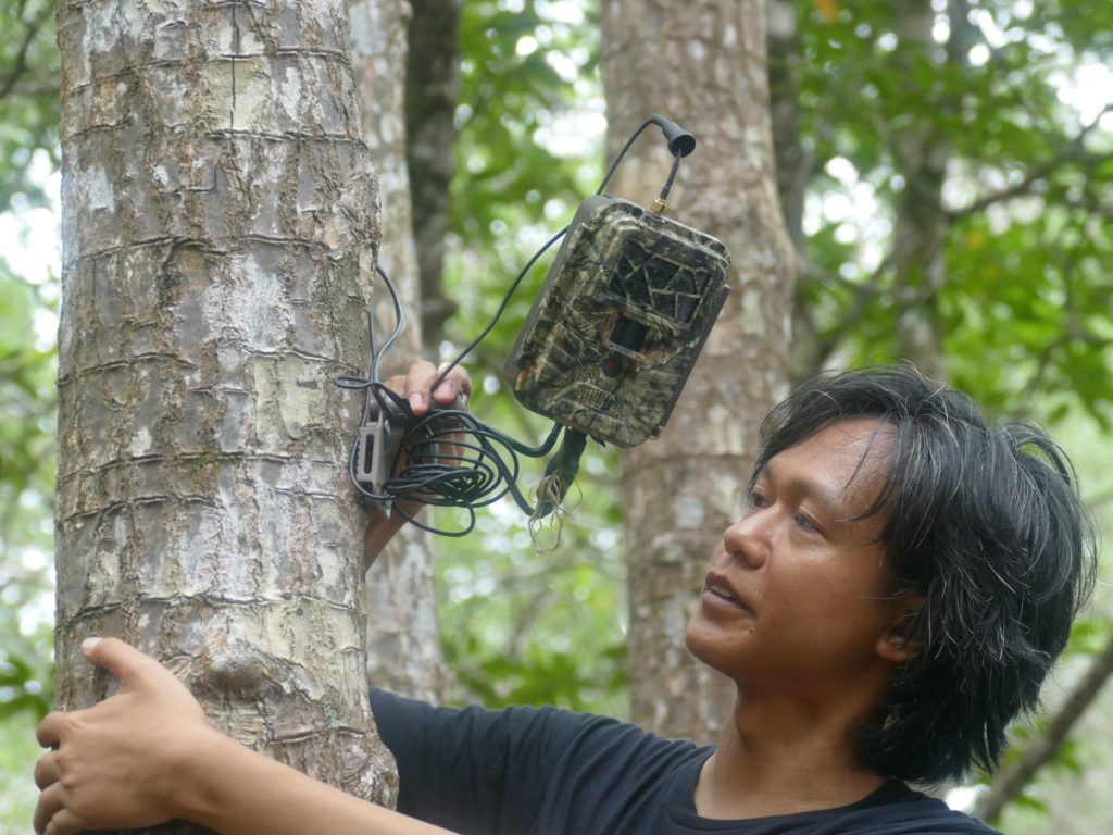 Checking an anti-poaching surveillance camera. (Photo by Mike Appleton)