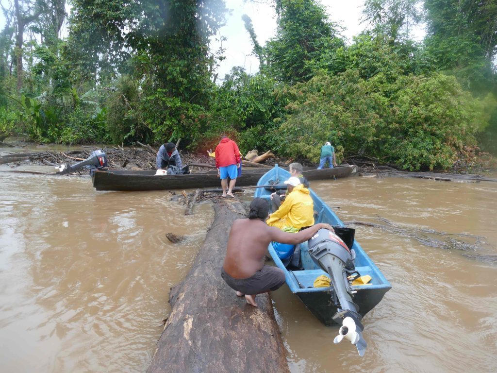 Hauling our boats across a fallen tree.