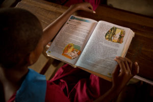 Child reading book, exploring and learning values