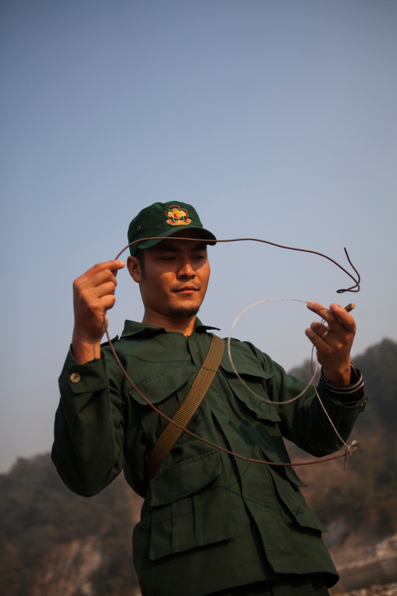 A ranger holding a poachers snare. Royal Manas National Park, Bhutan.