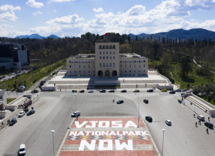 A huge banner in Tirana in Albania that says "Vjosa National Park Now."
